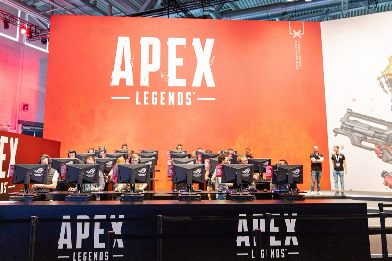Rows of players competing beneath an Apex Legends stage banner at Gamescom 2019