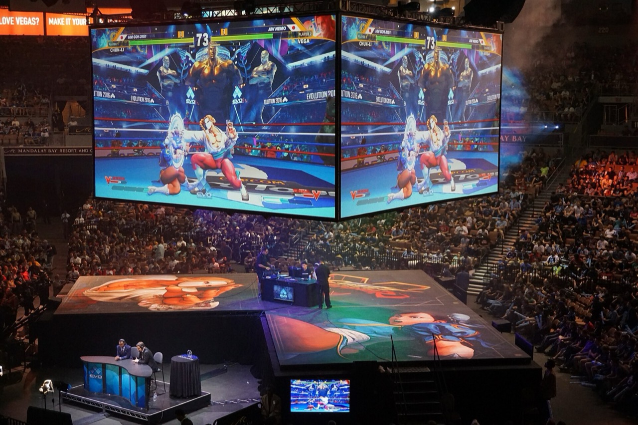 Fighting-game match on the central screens above the Evo 2016 arena stage