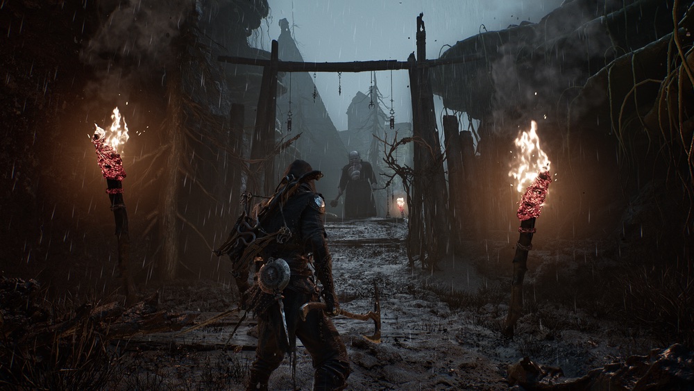 A warrior entering a torchlit settlement in Mortal Shell II