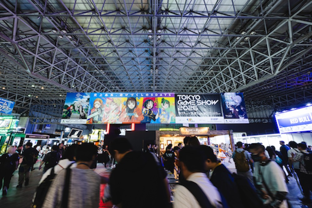 Visitors walk beneath the Tokyo Game Show 2026 sign in the Makuhari Messe exhibition hall