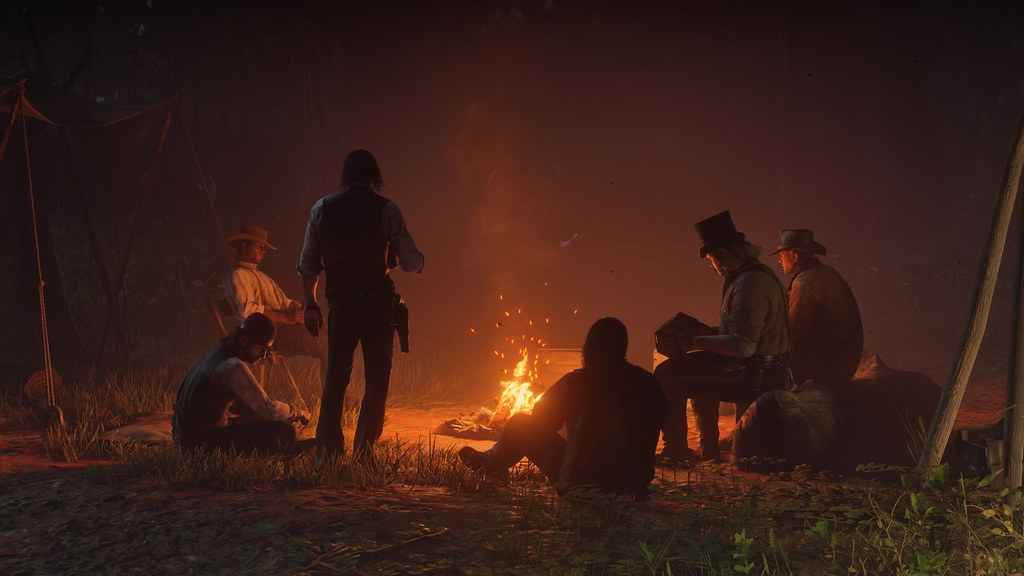 Arthur and the Van der Linde gang gathered around their campfire