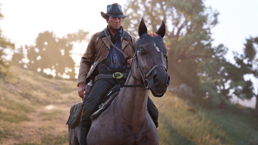 Arthur standing beside his saddled horse on a country trail